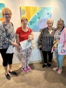 Artist Phyllis Elrich (3rd from left) &amp; visitors